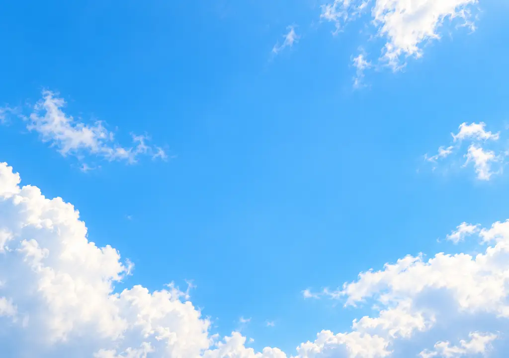 Bright blue sky with soft white clouds